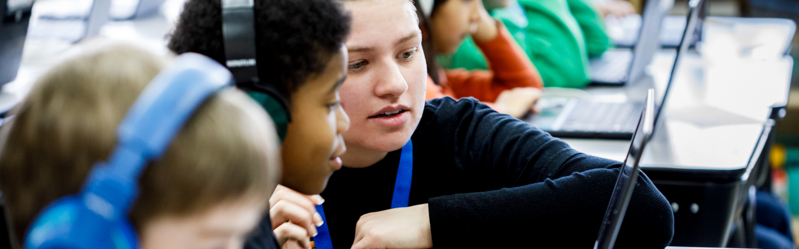 an elementary school teacher working with a student